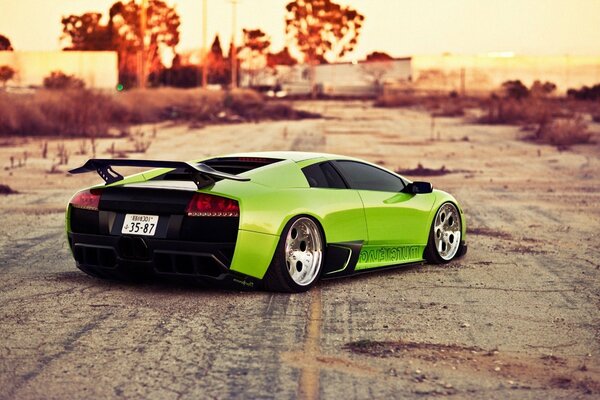 Light green lamborghini murcielago on large chrome wheels