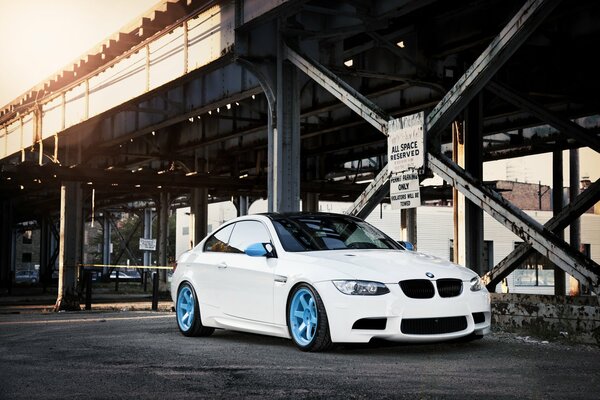 There is a beautiful, white car on the road