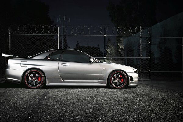 Autocar Nissan spends the night near a fence with barbed wire