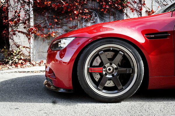 There is a beautiful, red car on the road