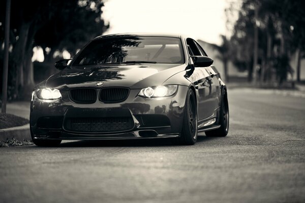 BMW headlights glow black and white photo