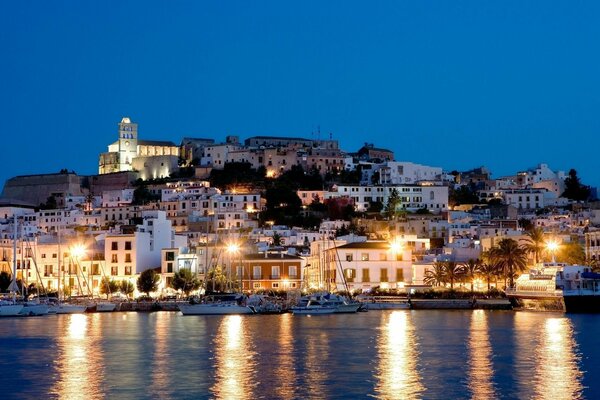 Evening city on the river and clear blue sky