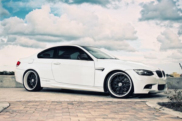 BMW blanc sur la route entre les nuages