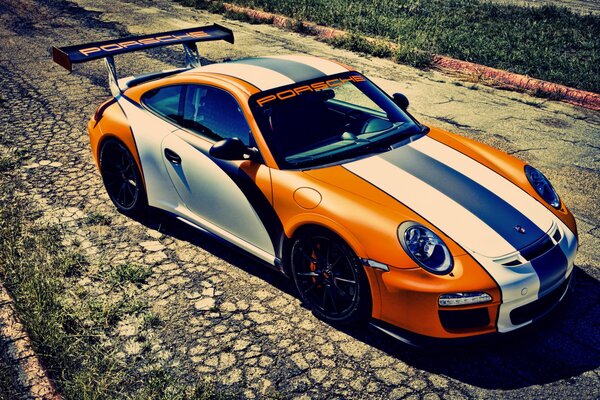 Orange Porsche on a deserted road