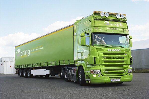 A big green truck in the parking lot