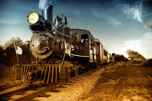 Retro steam locomotive on rails, with the spotlight on