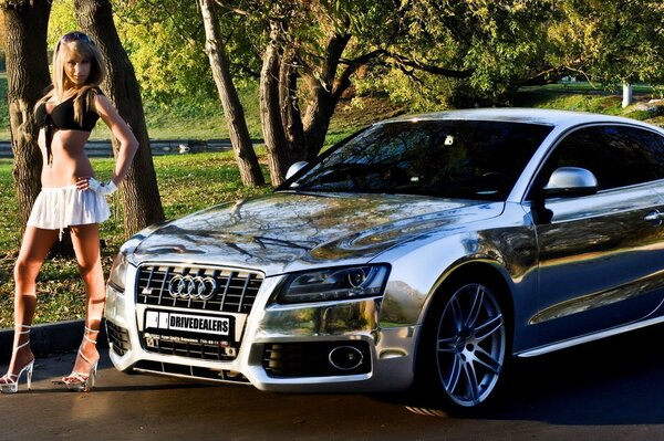 Beautiful girl near chrome car