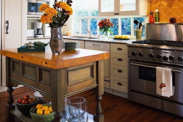 Cozy kitchen with bright flowers in vases