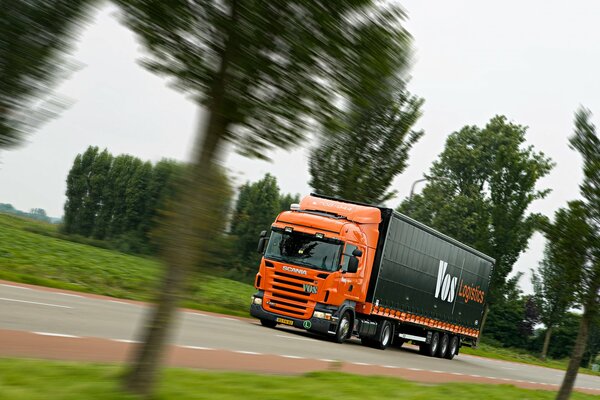 A tractor truck in the back of a red color