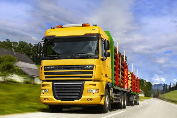 Grande camion giallo che trasporta la foresta