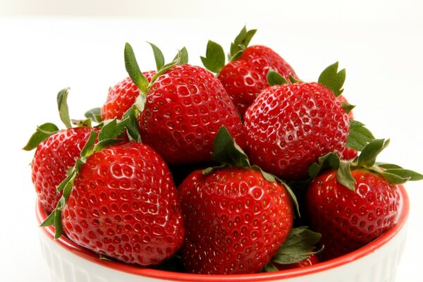 Sweet strawberries in a plate on the table