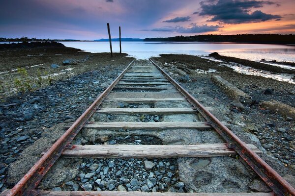 Abandoned railway by the lake