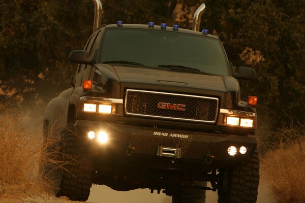 Big gmc pickup truck with lights on the road