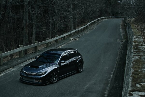 Subaru Impreza hatchback on a country road