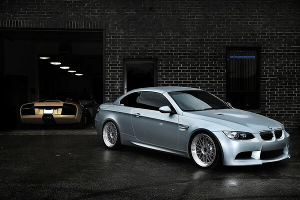 Photo of a BMW in a black brick garage