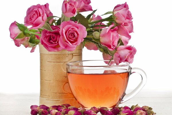 A cup of tea near a cart with roses