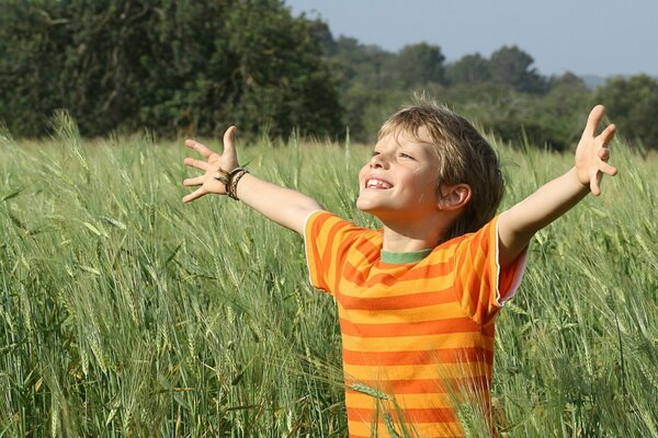 Happy little boy on the background of nature