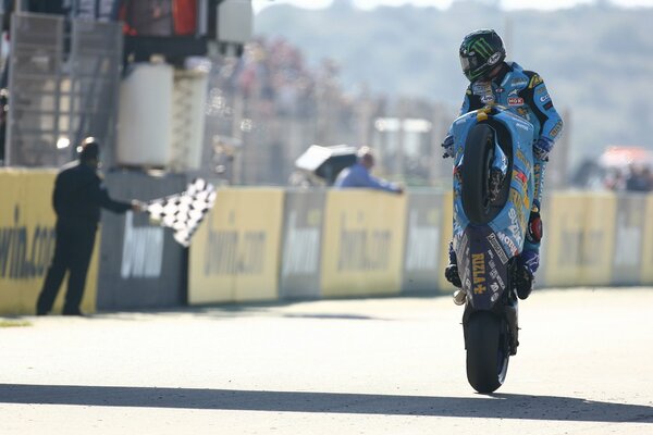 A motorcyclist rides on one wheel