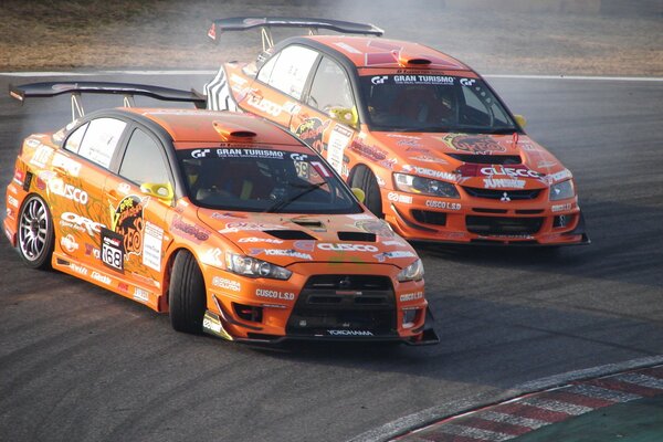 Mitsubishi evo car in pair drift