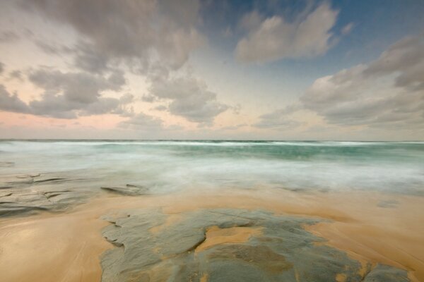 The horizon of the sea with a rocky shore