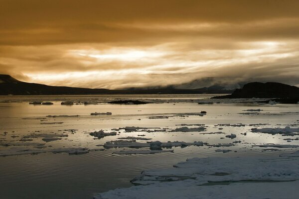 Ice floating in the water against the background of clouds