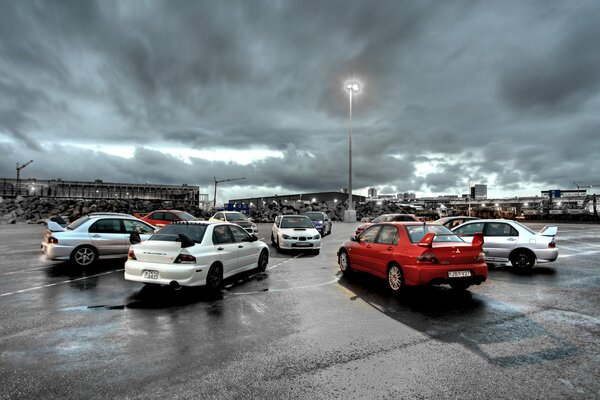 Sports cars against a cloudy sky