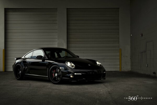 A black car in a tuning garage