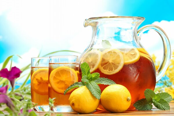 Decanter and glasses of tea with lemon