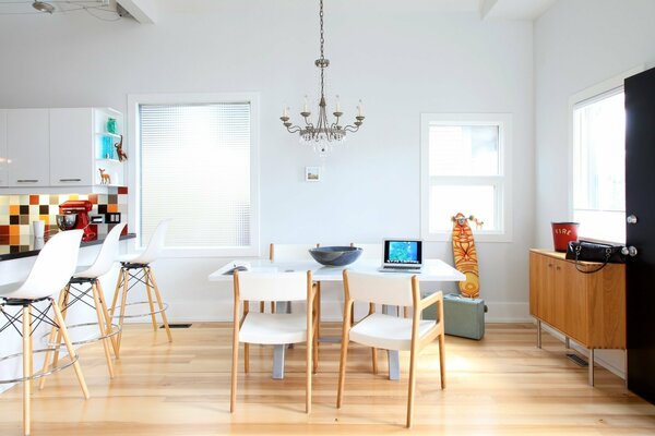 Snow-white kitchen with chandelier and chairs