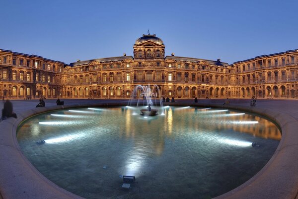 France. The lights of the fountain in the Louvre