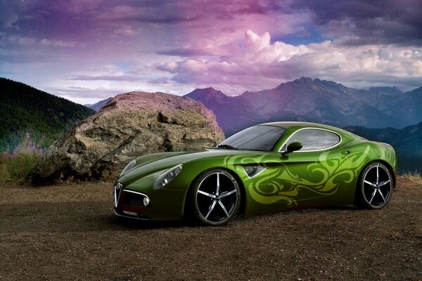 Sports car on the background of mountains and clouds