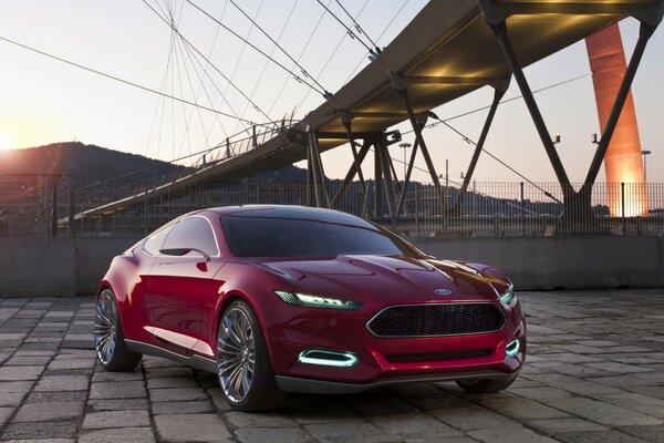 Captivating Ford EvoS in bright red against a sunset background