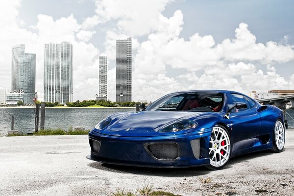 Blue Ferrari on the city embankment