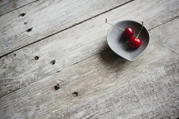 Two cherries in a bowl