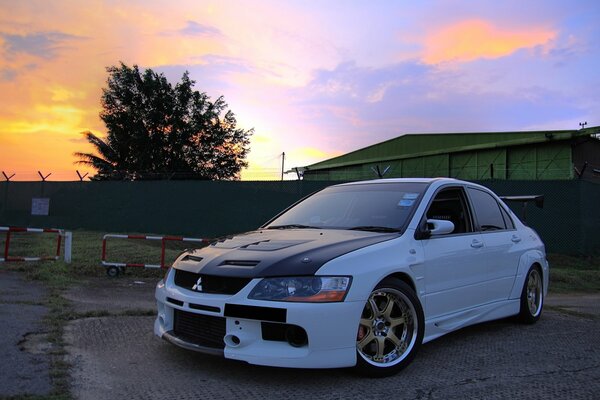 White tuned mitsubishi in the sunset