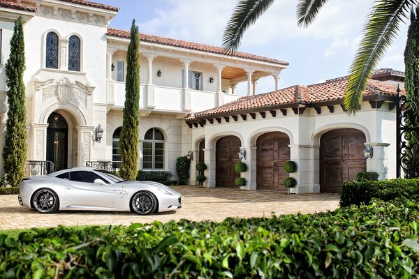 An expensive mansion in a southern country and a car