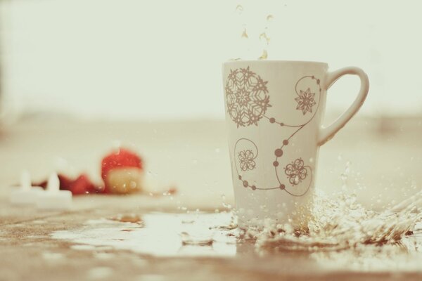 High white cup with patterns. Water splashes