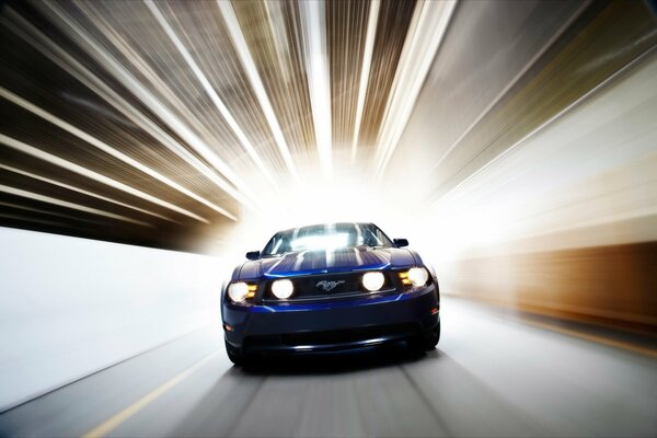 Blue auto Ford Mustang at speed