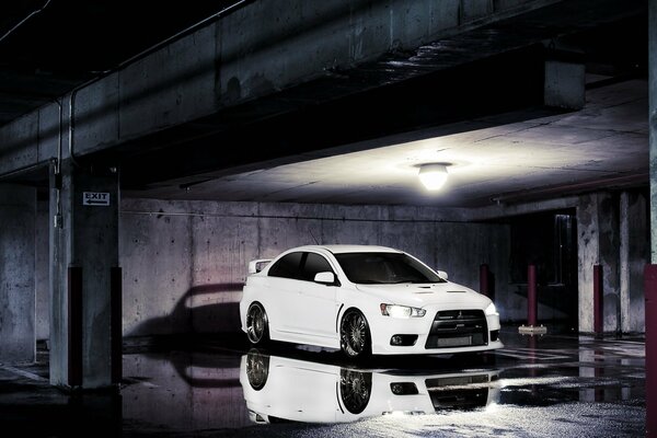 Mitsubishi evolution 10 white in the parking lot