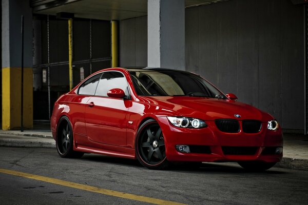 Red sports car on the background of the house