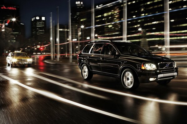 Black volvo xc90 on the street of the night city