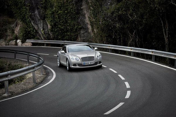 A Bentley entering a turn on the highway