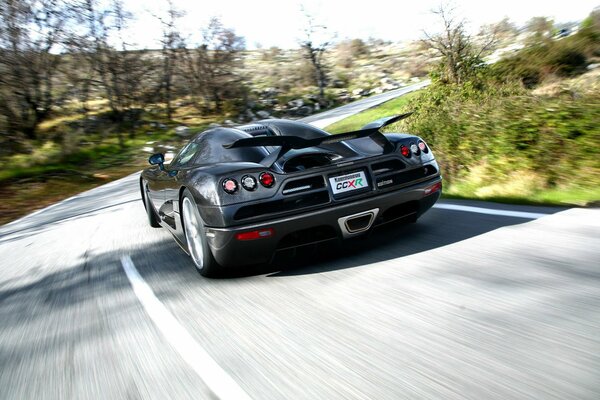 A sporty black car in motion