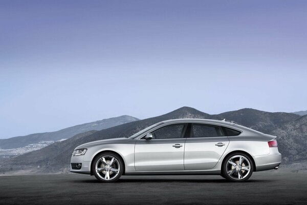 Audi silver color on the background of mountains