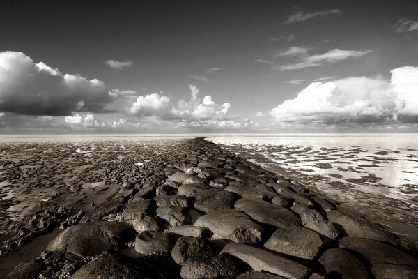 There are only a lot of rocks on the horizon and gray clouds above them