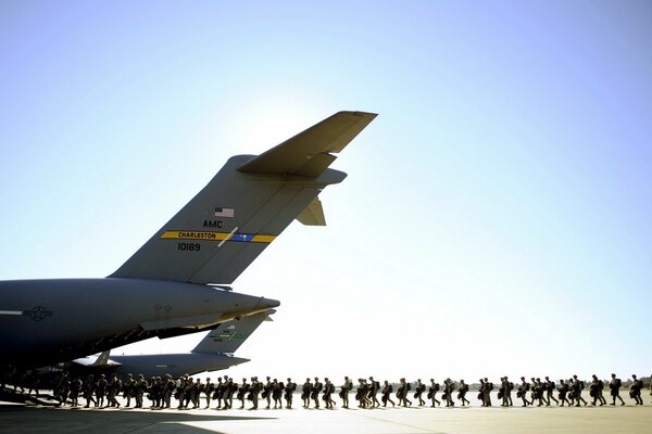 Soldiers are being loaded into a plane at the airfield