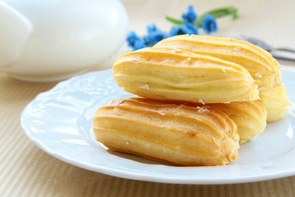 A plate of cream cakes on the table