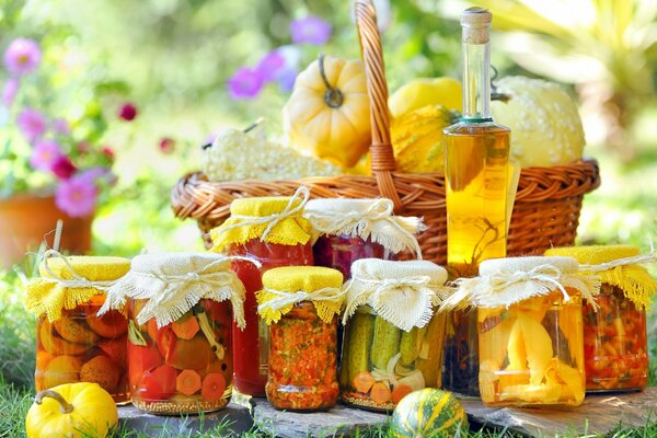 Jars of pickles. Flowers and pumpkins. in the basket