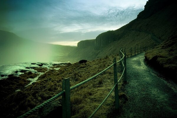 The path along the path along the fence in the fog