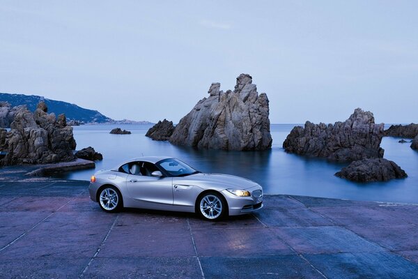 Car near the water on the background of rocks